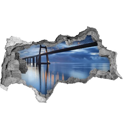 Adesivo con vista dietro il muro Un ponte sull'acqua in una scena notturna