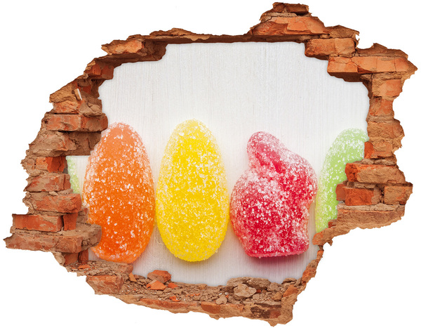 Adesivo con buco sbrecciato Caramelle gommose dolci in un buco nel muro