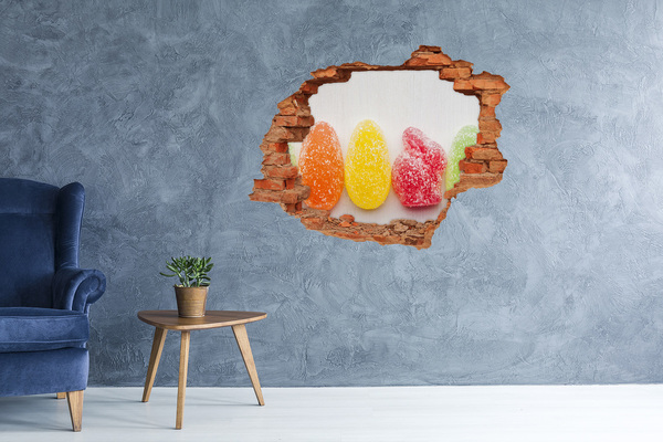 Adesivo con buco sbrecciato Caramelle gommose dolci in un buco nel muro
