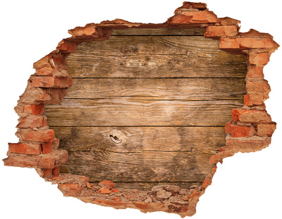 Adesivo con buco sbrecciato Un muro danneggiato con assi di legno