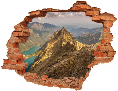 Adesivo effetto buco nel muro Paesaggio montano visto attraverso un buco nel muro
