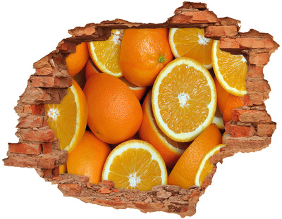 Adesivo con buco sbrecciato Arance fresche in un buco nel muro